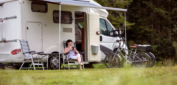 woman sat outside motorhome